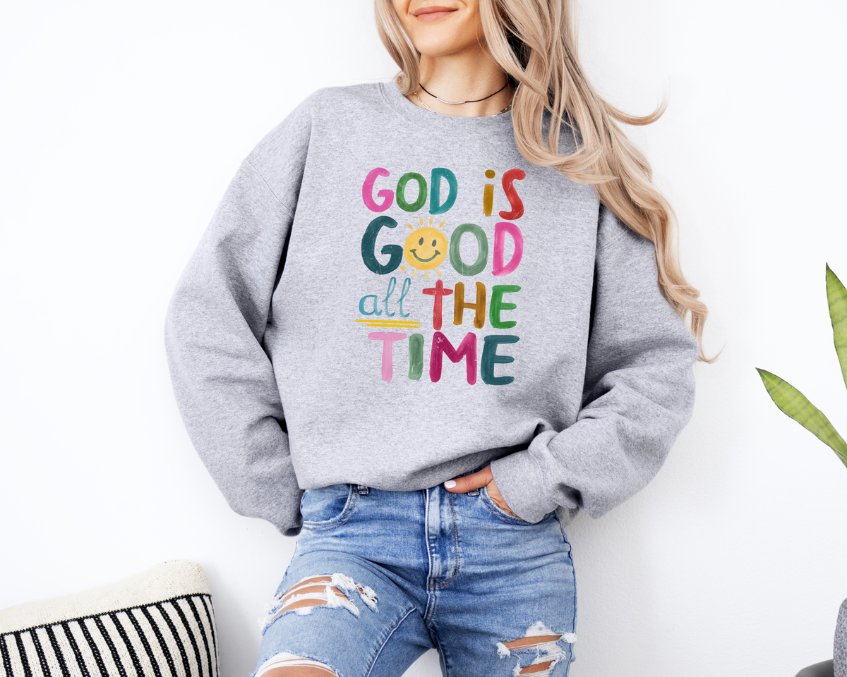 Gray God is good shirt with a rainbow colored painted design that says "god is good all the time."