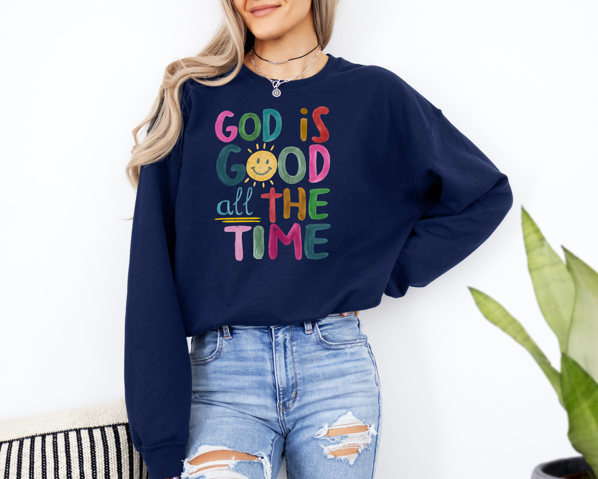 Navy God is good shirt with a rainbow colored painted design that says "god is good all the time."