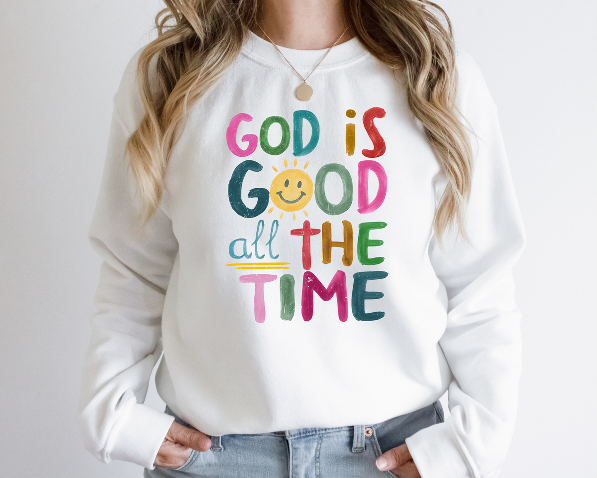White God is good shirt with a rainbow colored painted design that says "god is good all the time."