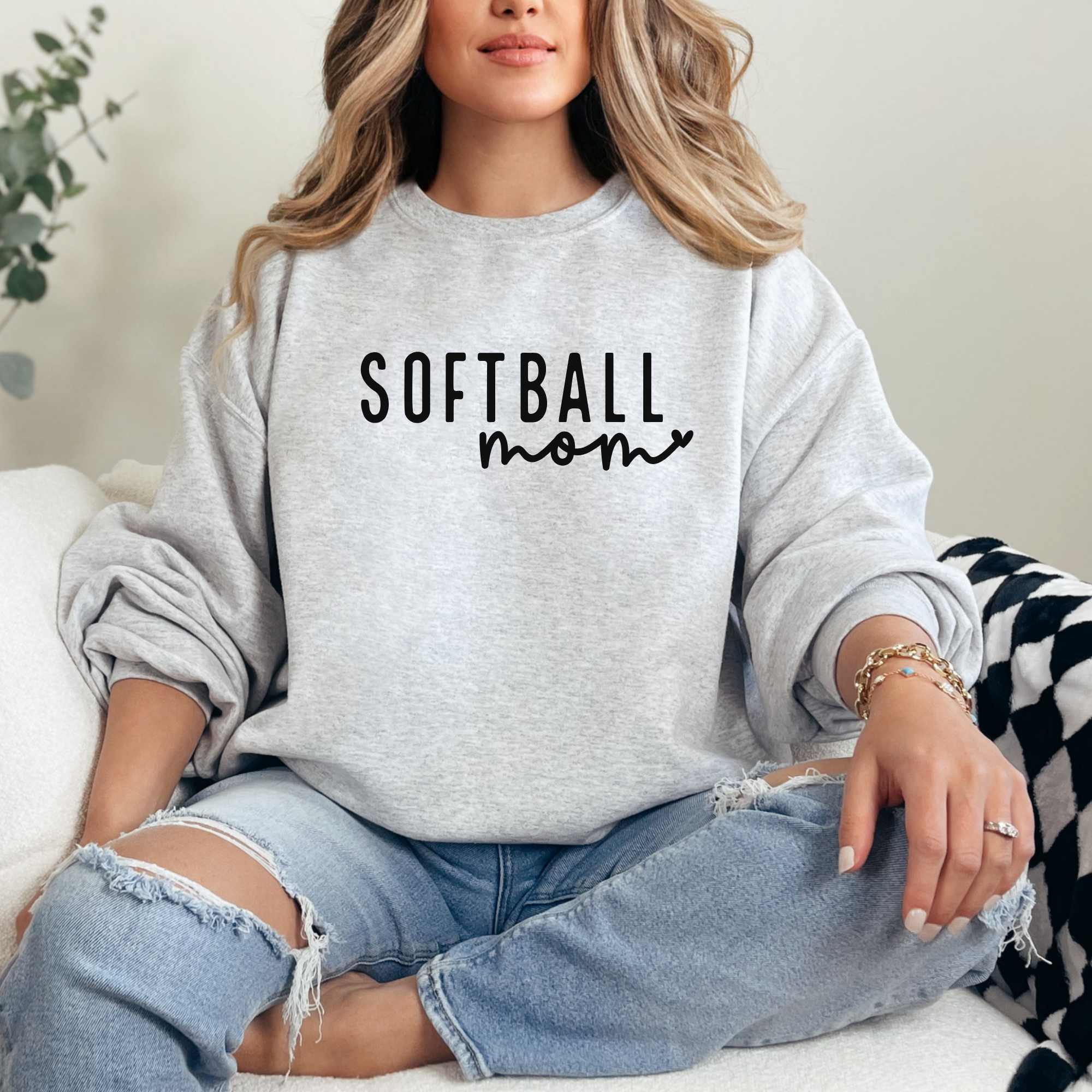 simple softball mom sweatshirt design with heart attached to the word mom in cursive. Color is ash design is black
