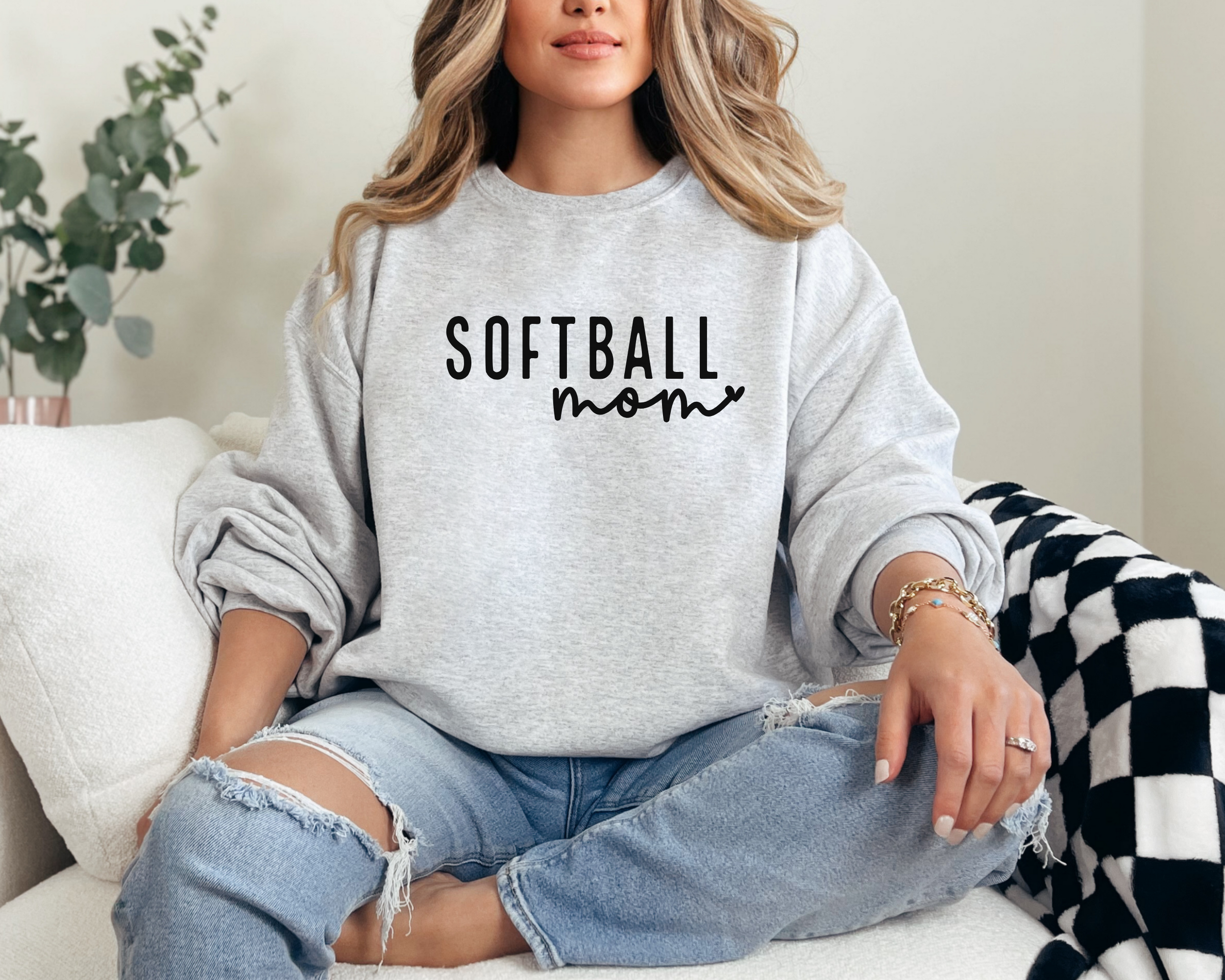 simple softball mom sweatshirt design with heart attached to the word mom in cursive. Color is ash design is black