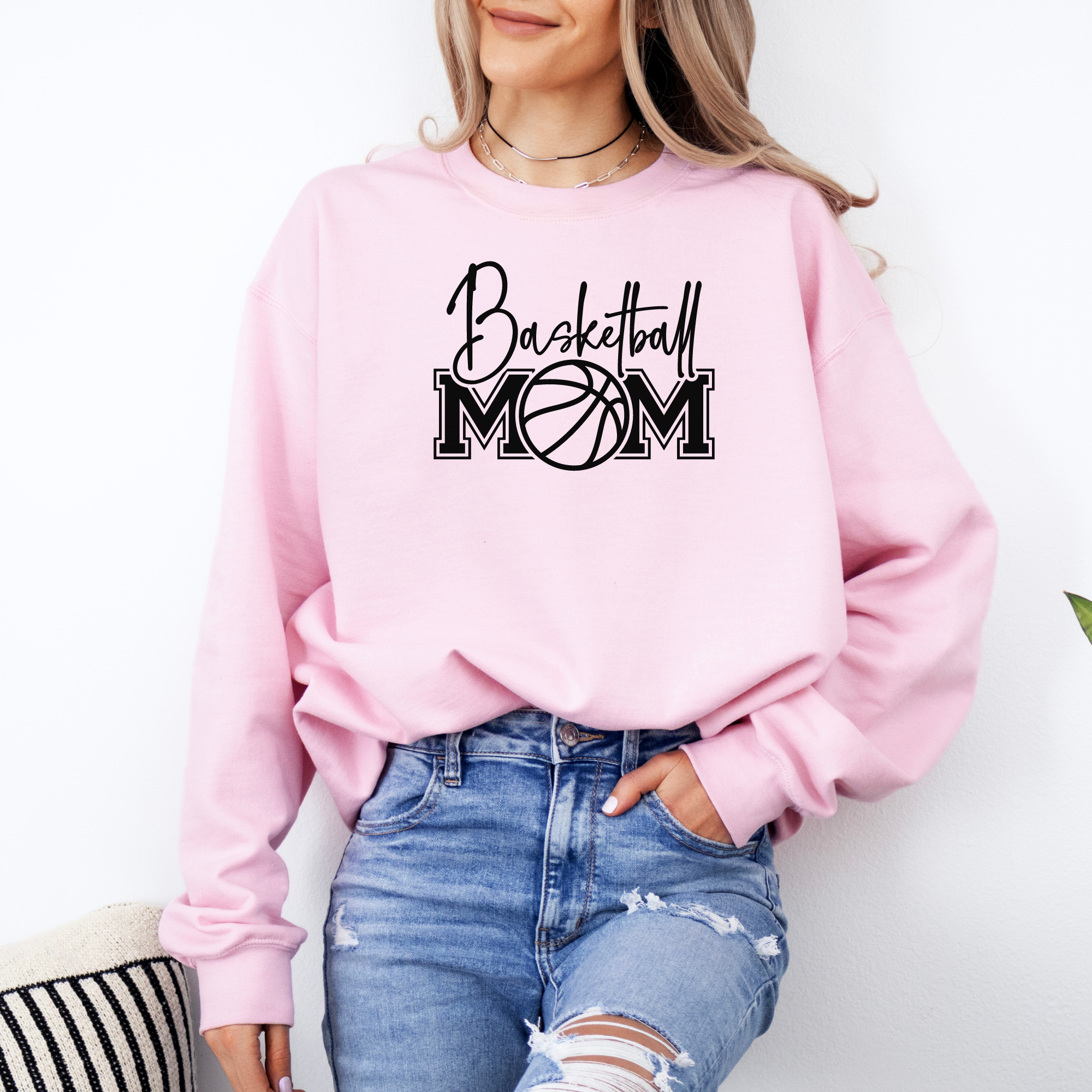 Basketball mom sweatshirt with a cute cursive font and a college text font. Great apparel for basketball games.