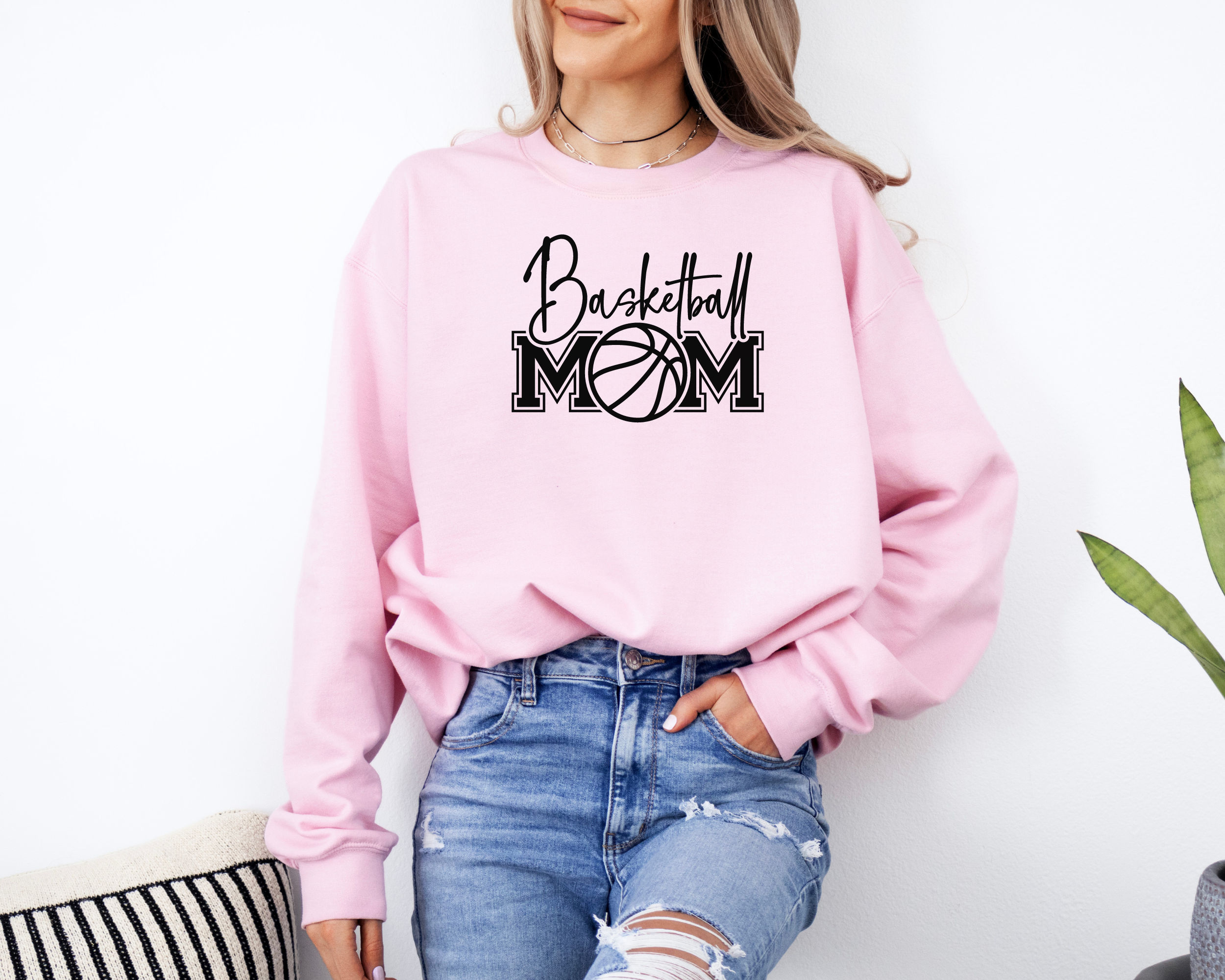 Basketball mom sweatshirt with a cute cursive font and a college text font. Great apparel for basketball games.