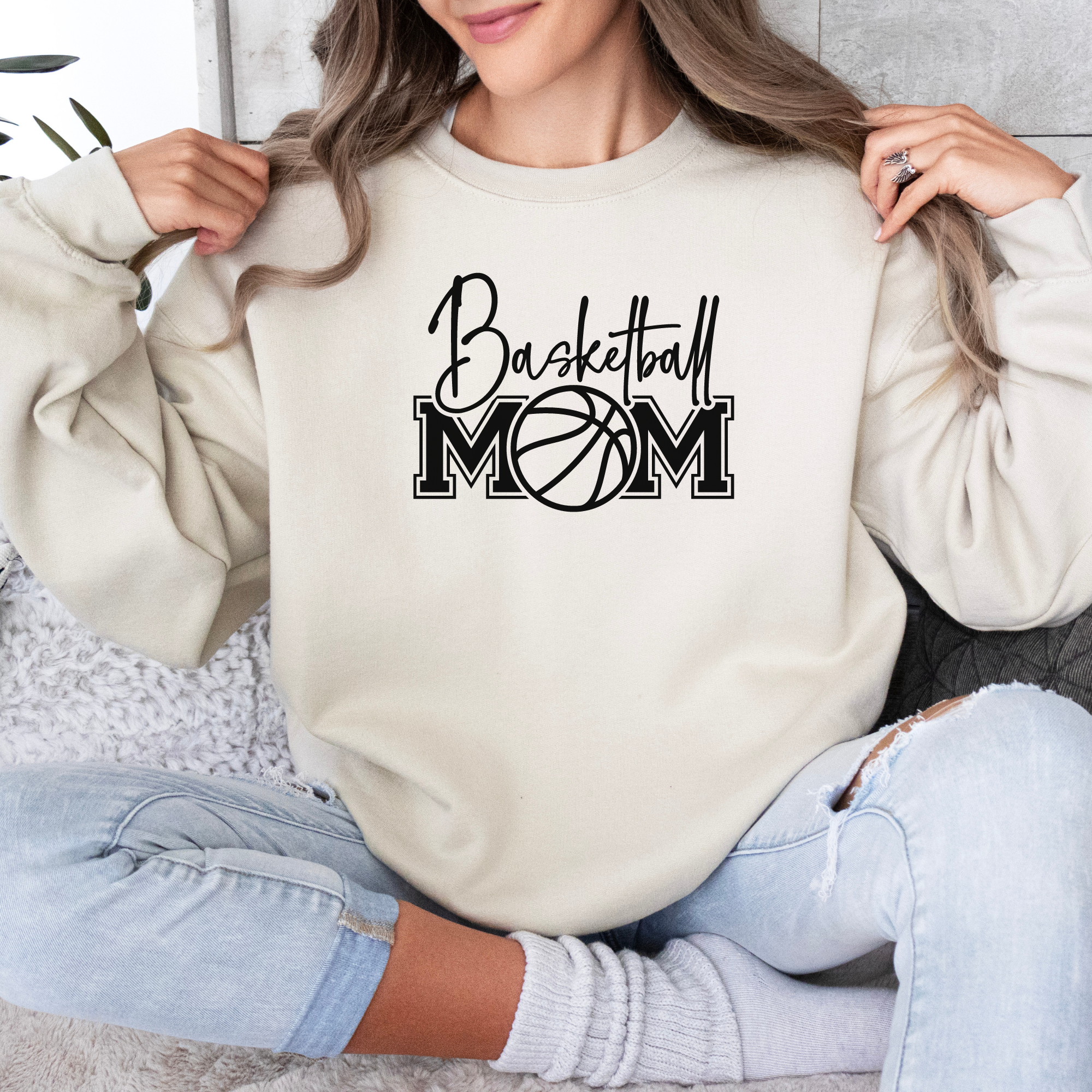 Basketball mom sweatshirt with a cute cursive font and a college text font. Great apparel for basketball games.