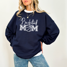 Basketball mom sweatshirt with a cute cursive font and a college text font.  Great apparel for basketball games.