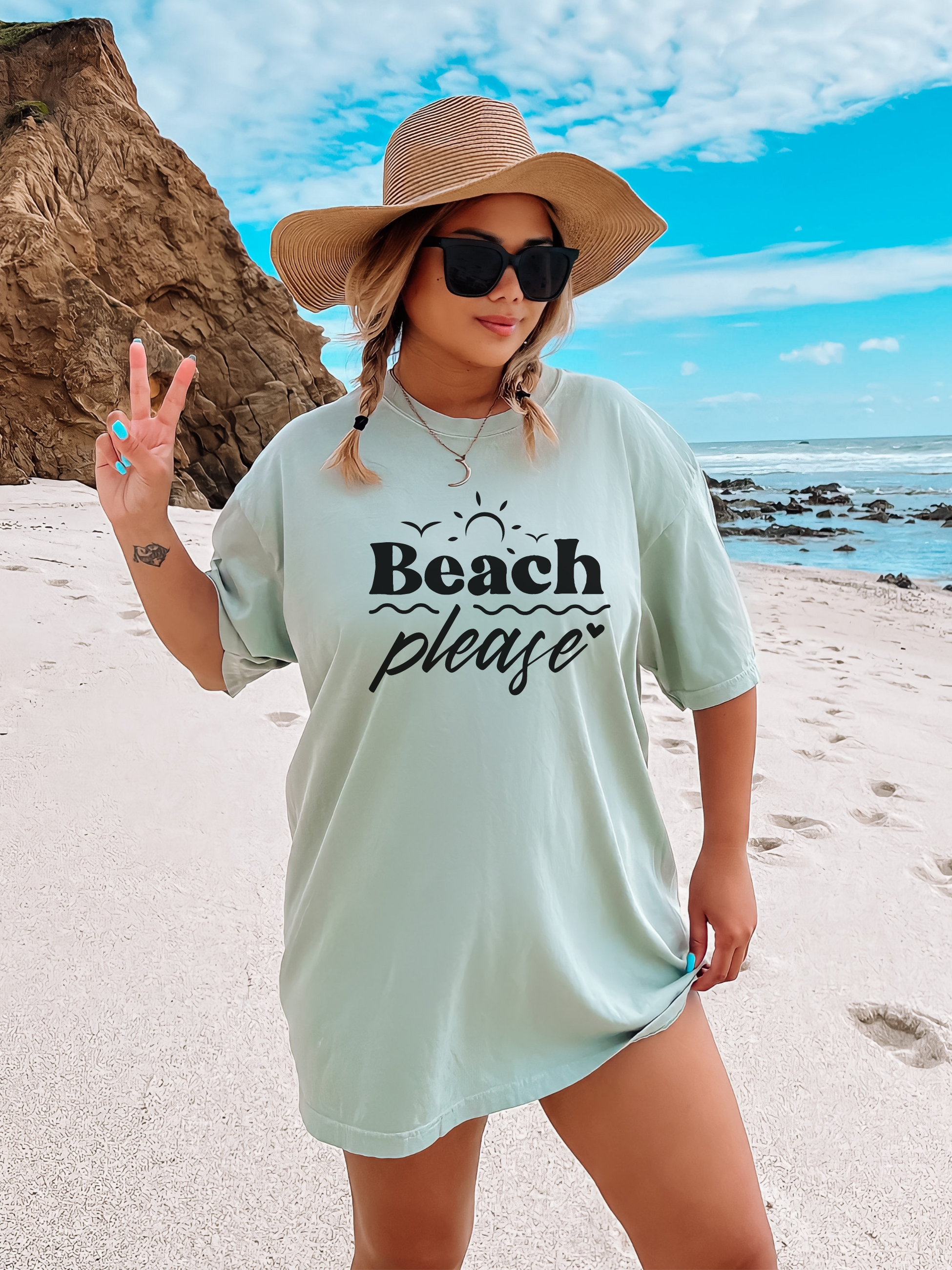 beach shirt that says beach please. Subtle smaller designs around the words are bird sun waves and heart. Made in the color bay in a comfort colors tee.
