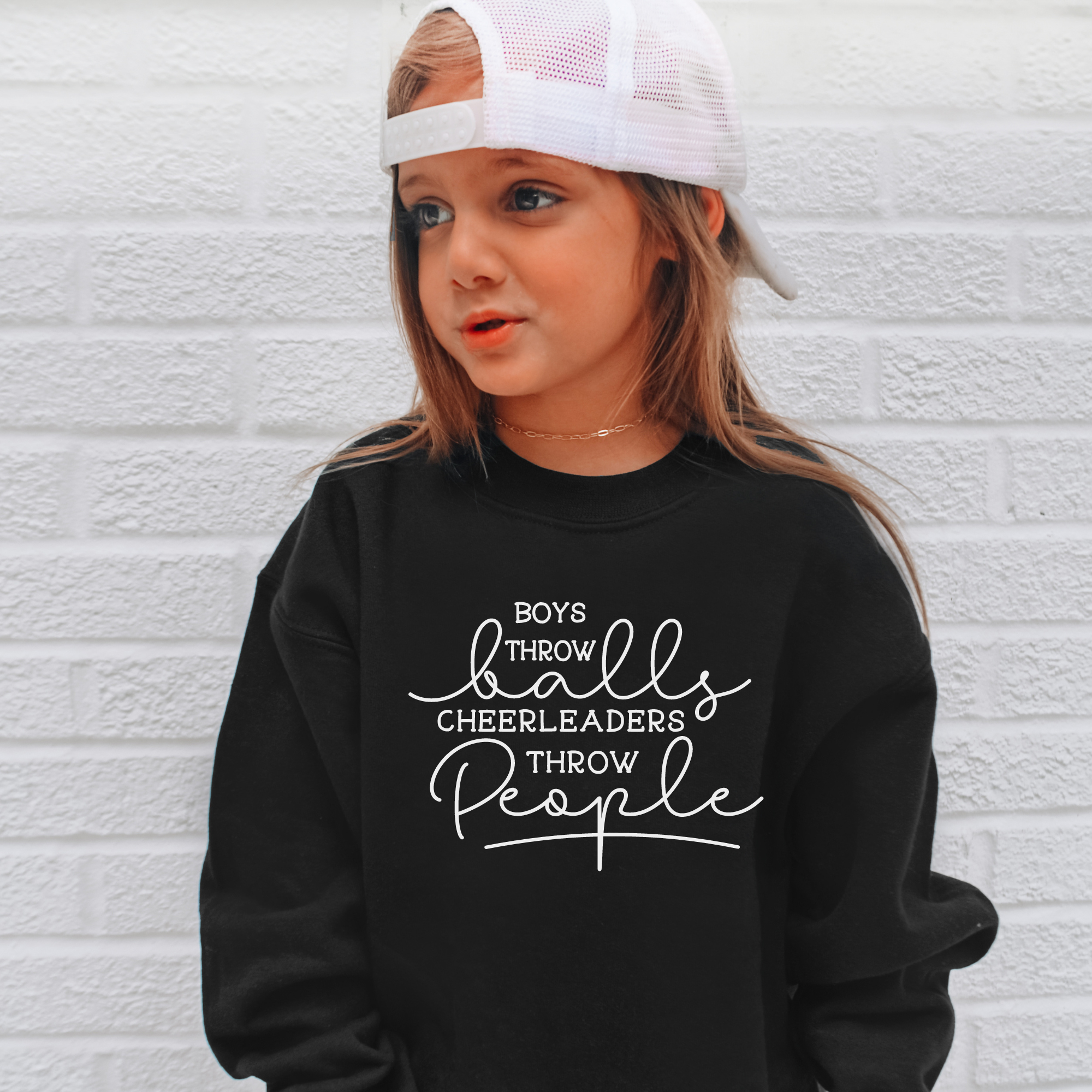 Funny cheer sweatshirt that says boys throw balls cheerleaders throw people in black