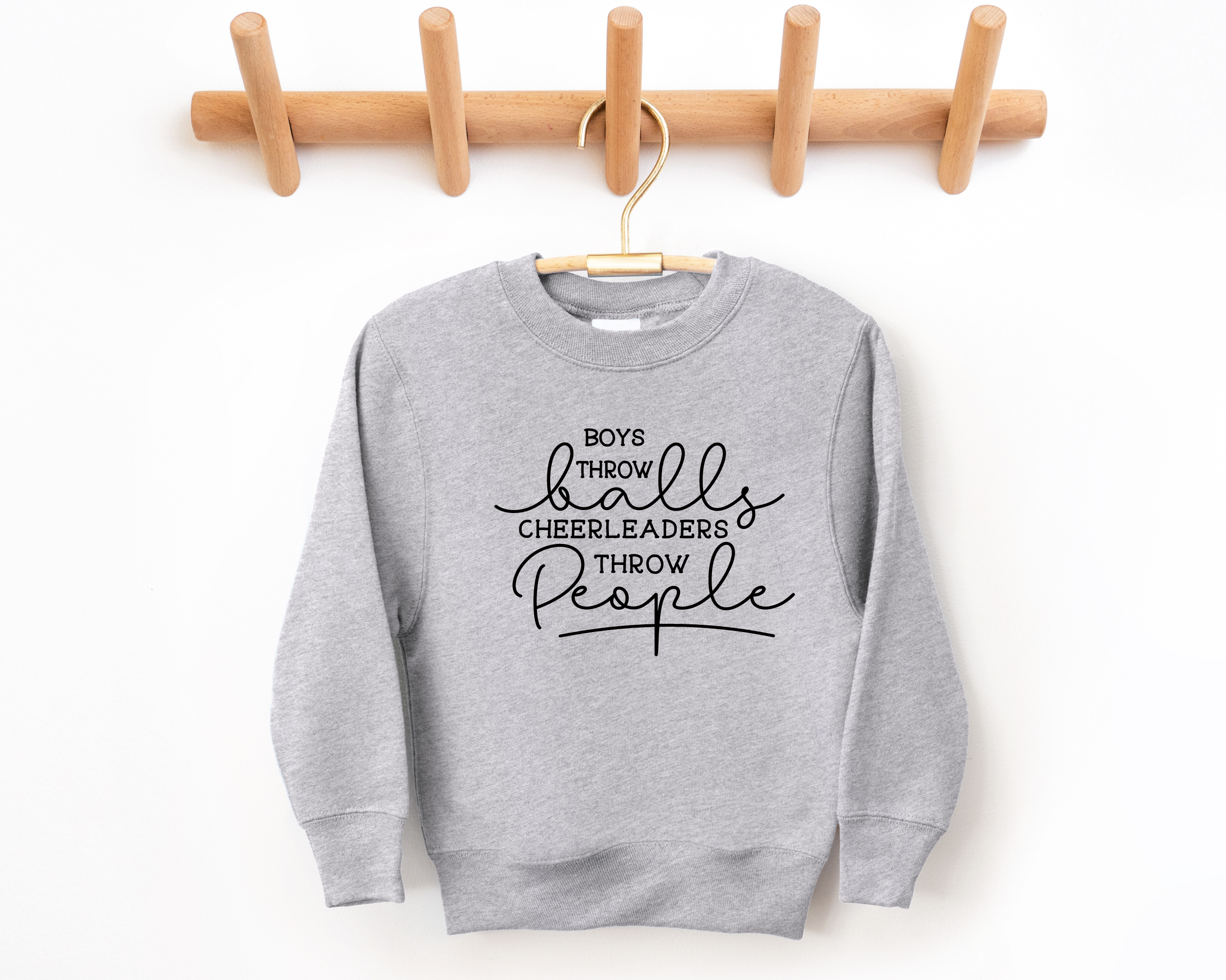 Funny cheer sweatshirt that says boys throw balls cheerleaders throw people in gray