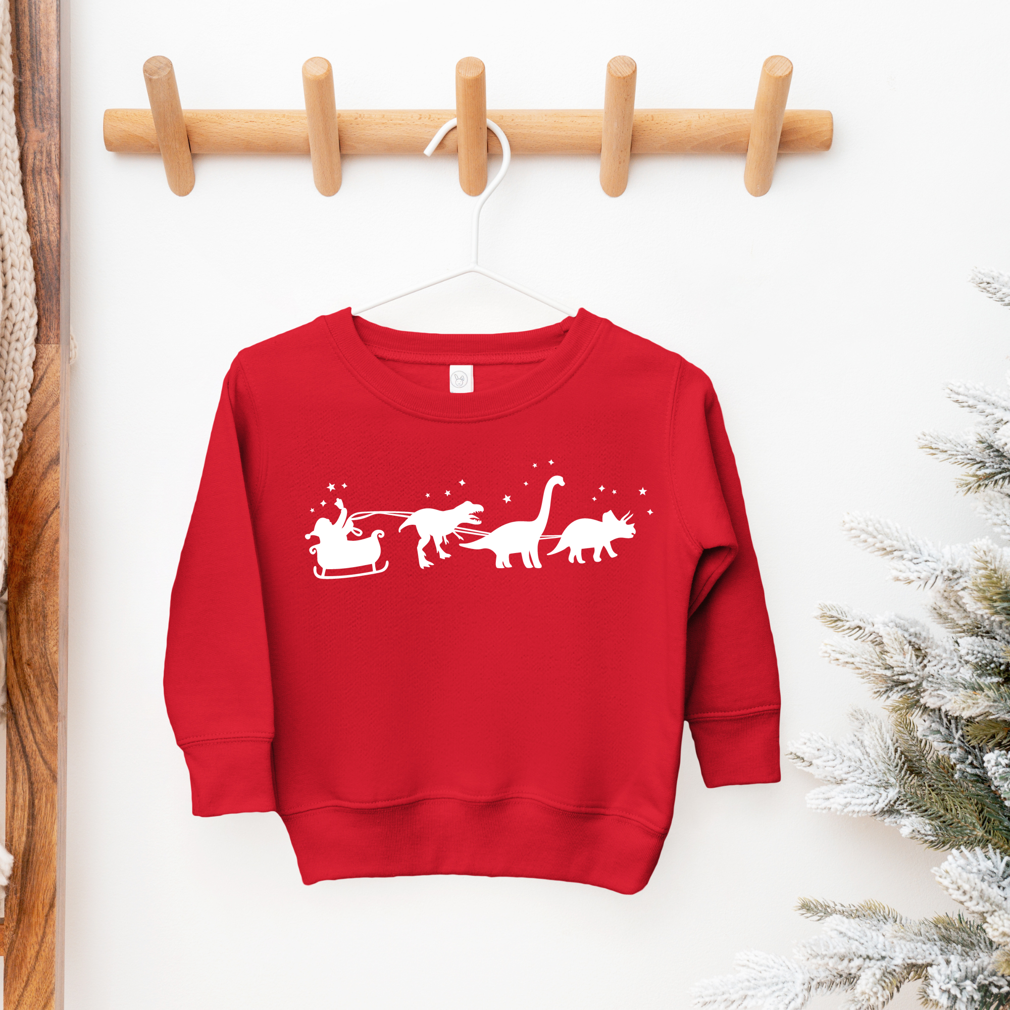 Toddler christmas sweatshirt with a santa sleigh and dinosaurs pulling the sleigh.