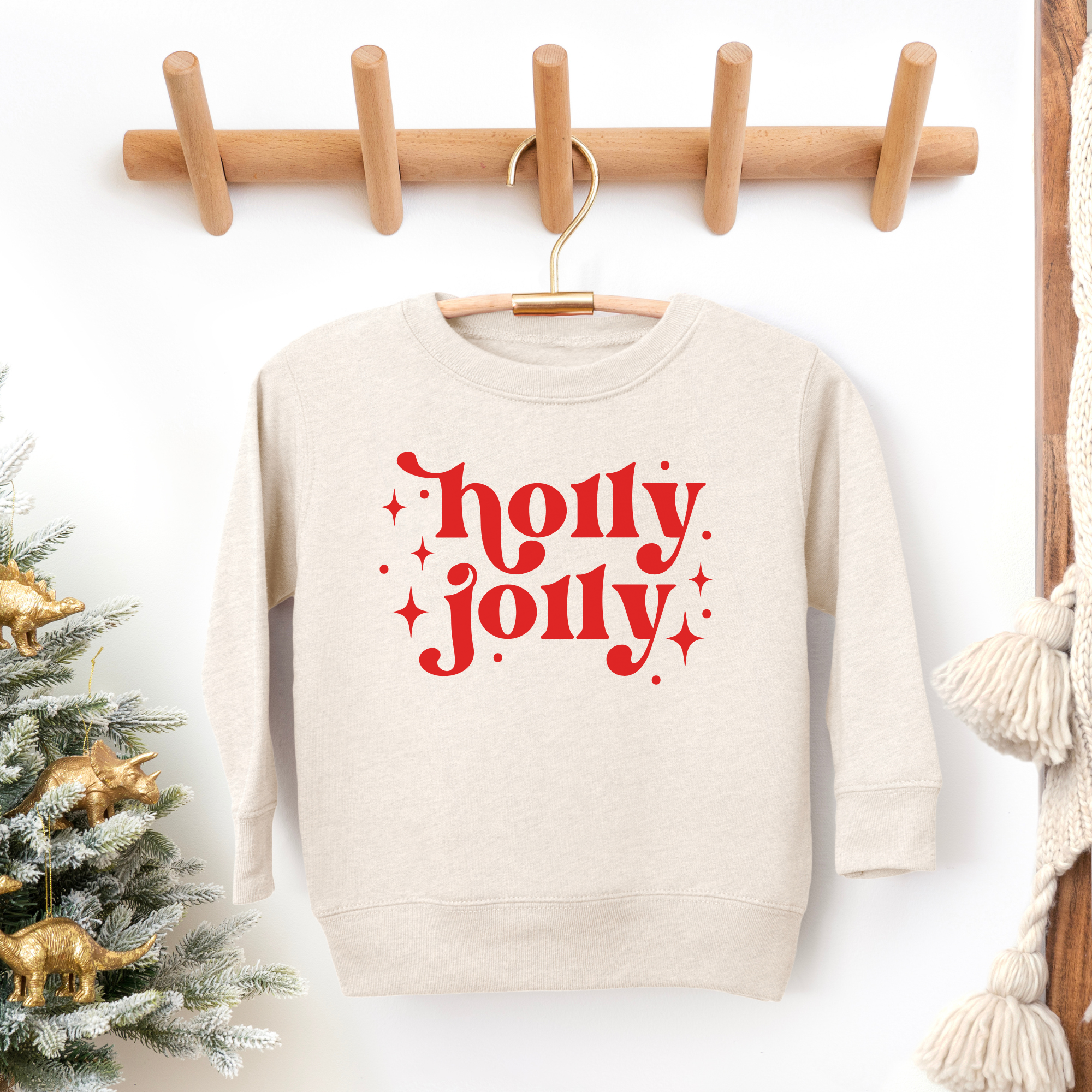 Holly jolly toddler christmas sweatshirt in heather natural with red text and little stars