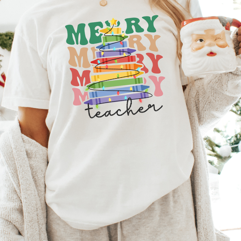 Cute Christmas tshirt for teachers that says merry teacher stacked with a crayon tree.