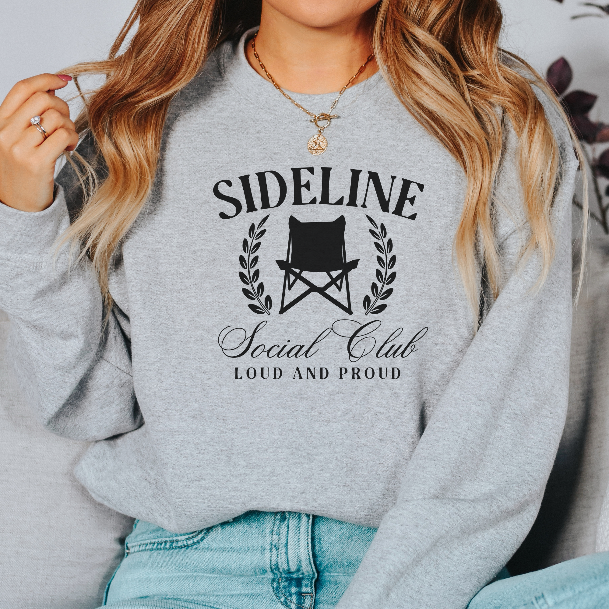 sports mom sweatshirt that says sideline social club loud and proud.