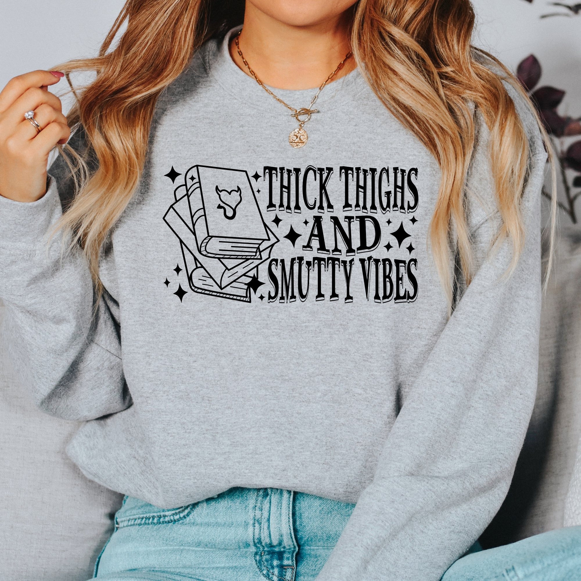 book lover sweatshirt that says thick thighs and smutty vibes